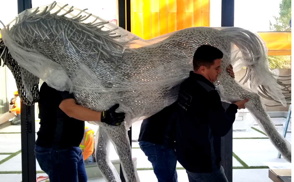 Professional crew delivering wrapped furniture